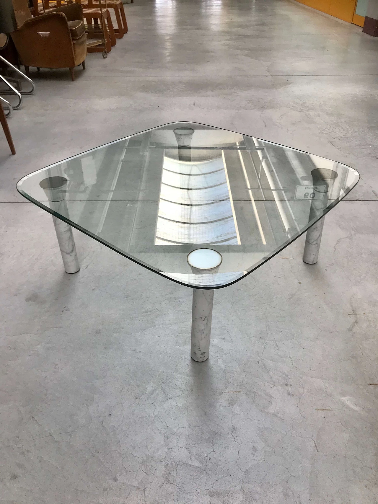 Glass top coffee table with marble legs, 60s 1166103