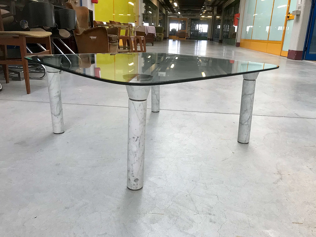 Glass top coffee table with marble legs, 60s 1166104