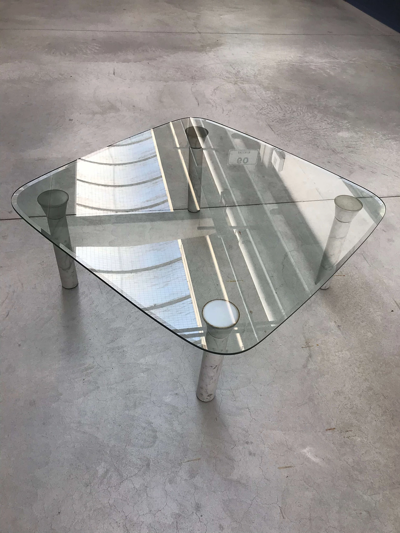 Glass top coffee table with marble legs, 60s 1166105