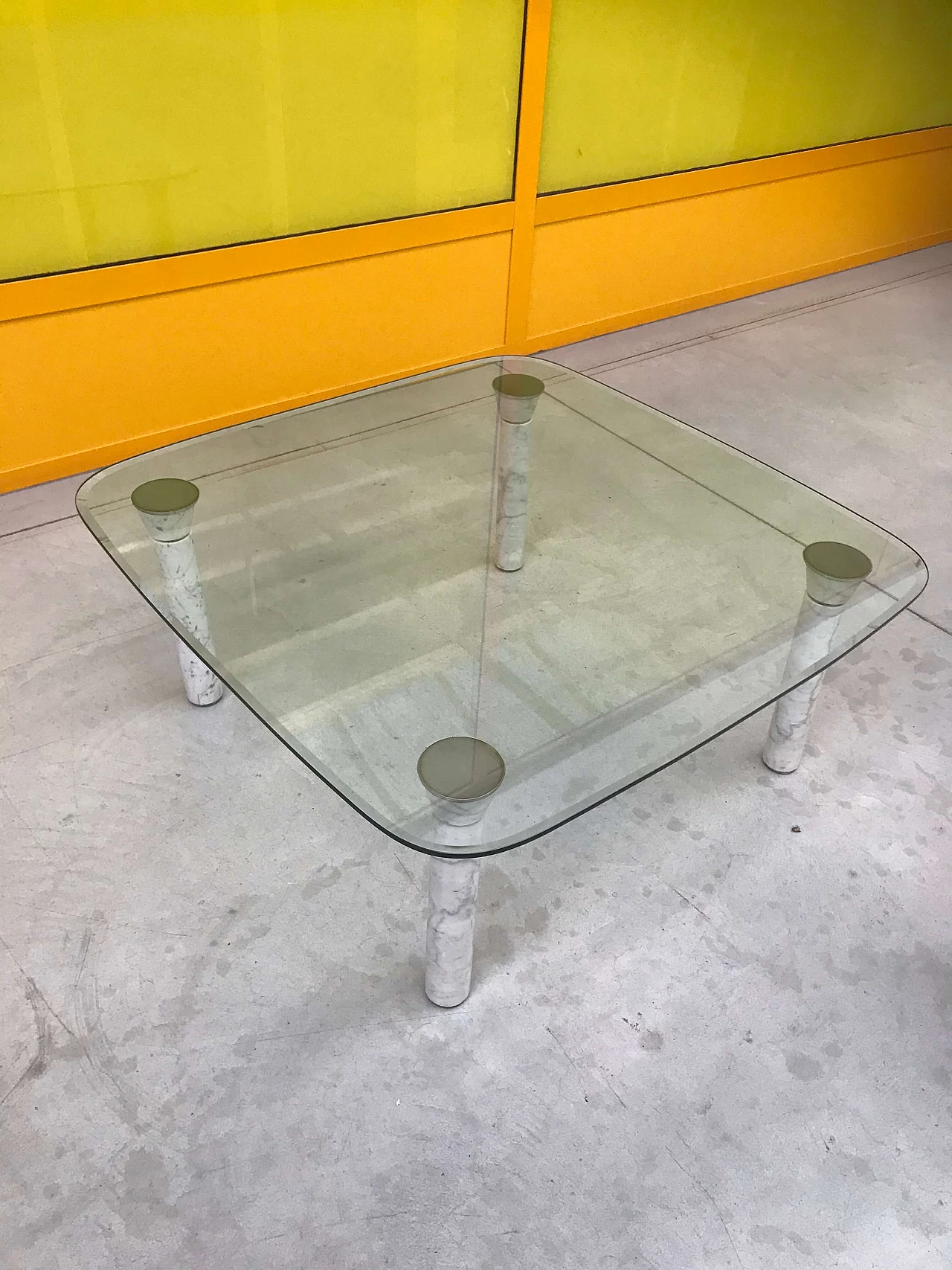 Glass top coffee table with marble legs, 60s 1166106