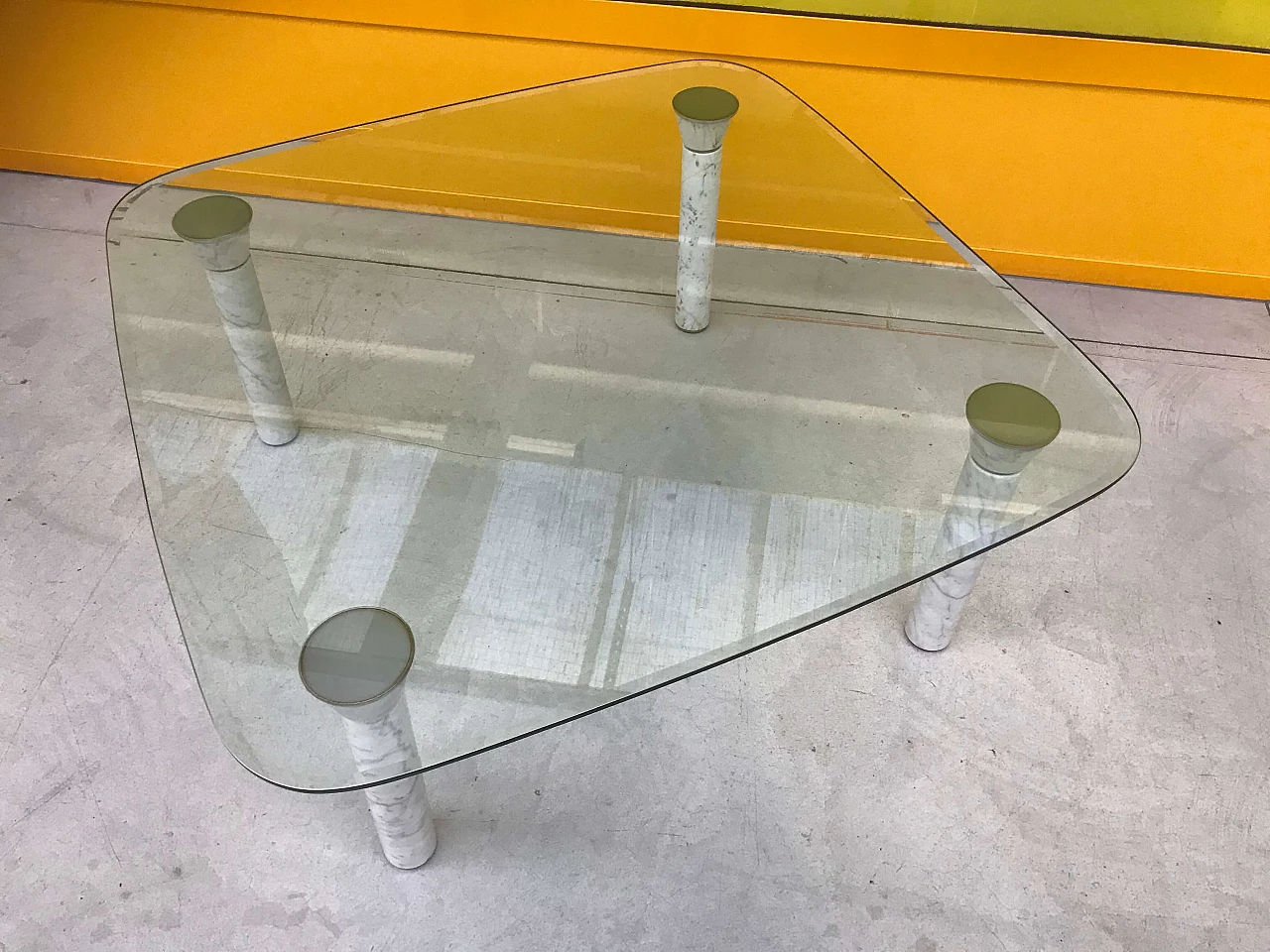 Glass top coffee table with marble legs, 60s 1166111