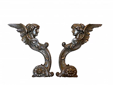 Pair of decorative elements representing winged figures in cast iron, 10s