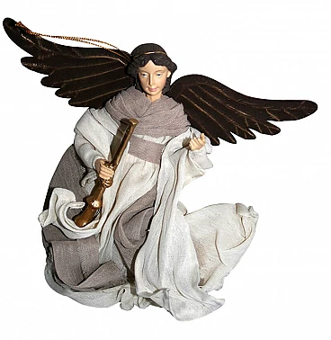 Sculpture of an angel in flight with trumpet made of fabric, resin and sheet metal