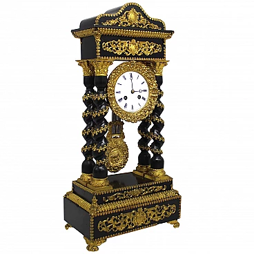 Napoleon III pendulum clock in ebonized wood and gilded bronzes, 19th century.