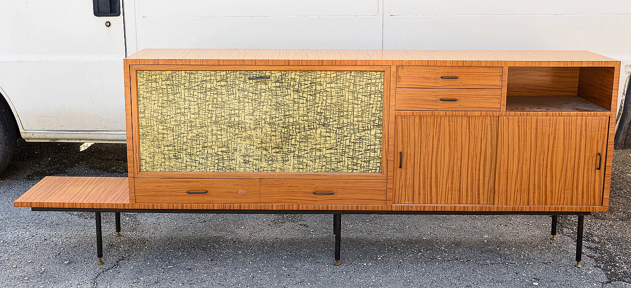 Sideboard in wood, painted metal and brass with decorated flap door, 60s 1470246