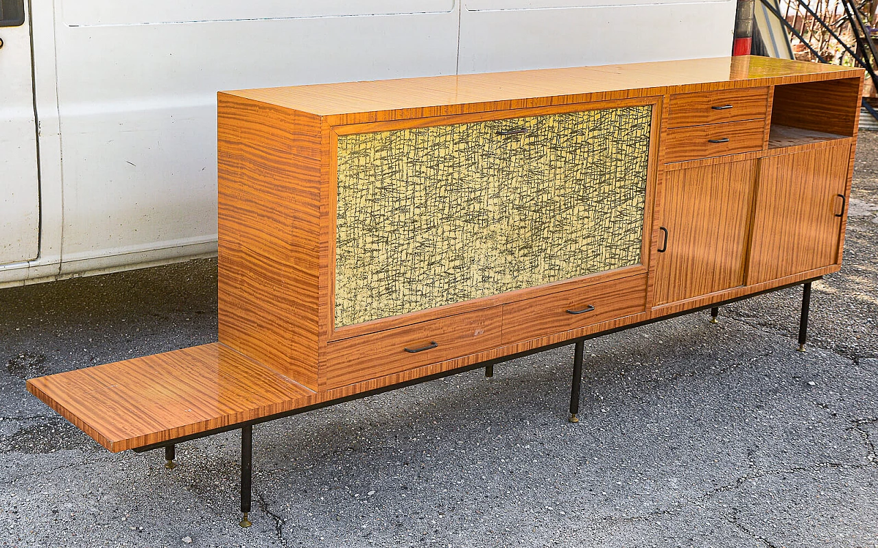 Sideboard in wood, painted metal and brass with decorated flap door, 60s 1470248
