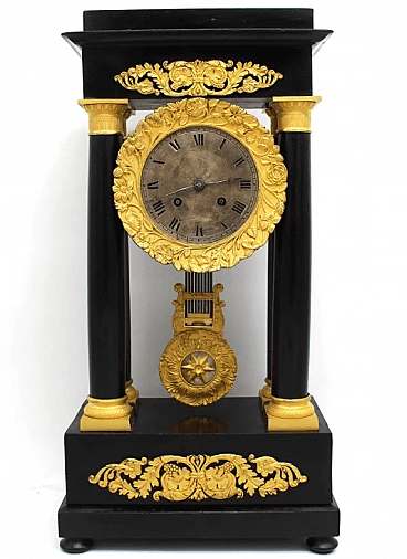 Empire style pendulum clock in ebonized wood, early 19th century