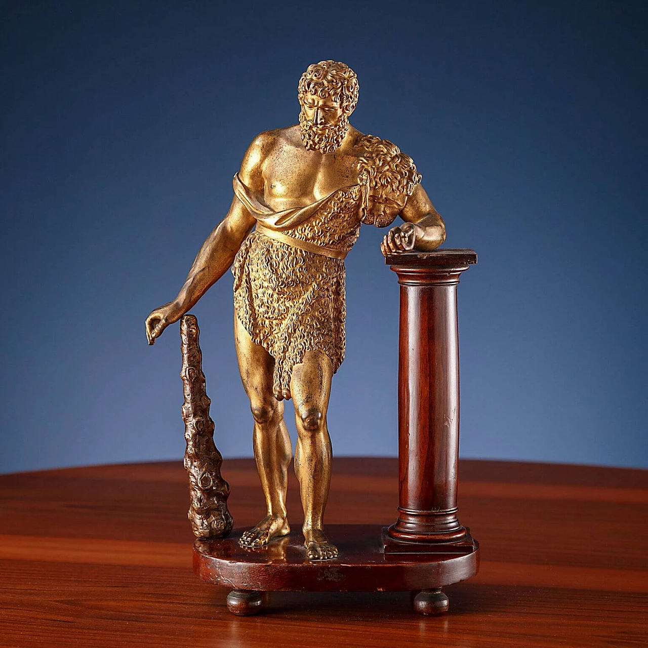 Statue of Hercules in gilt bronze resting on walnut column, 19th century 1