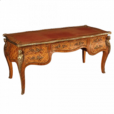 Carved wooden desk with bronze and brass decorations in Louis XV style
