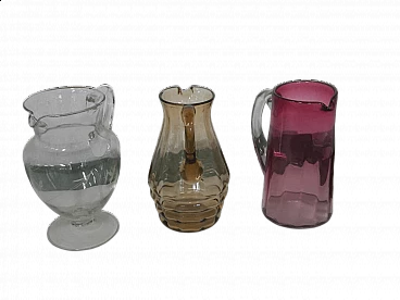 3 Brocche in vetro di diversi colori e forme, anni '50