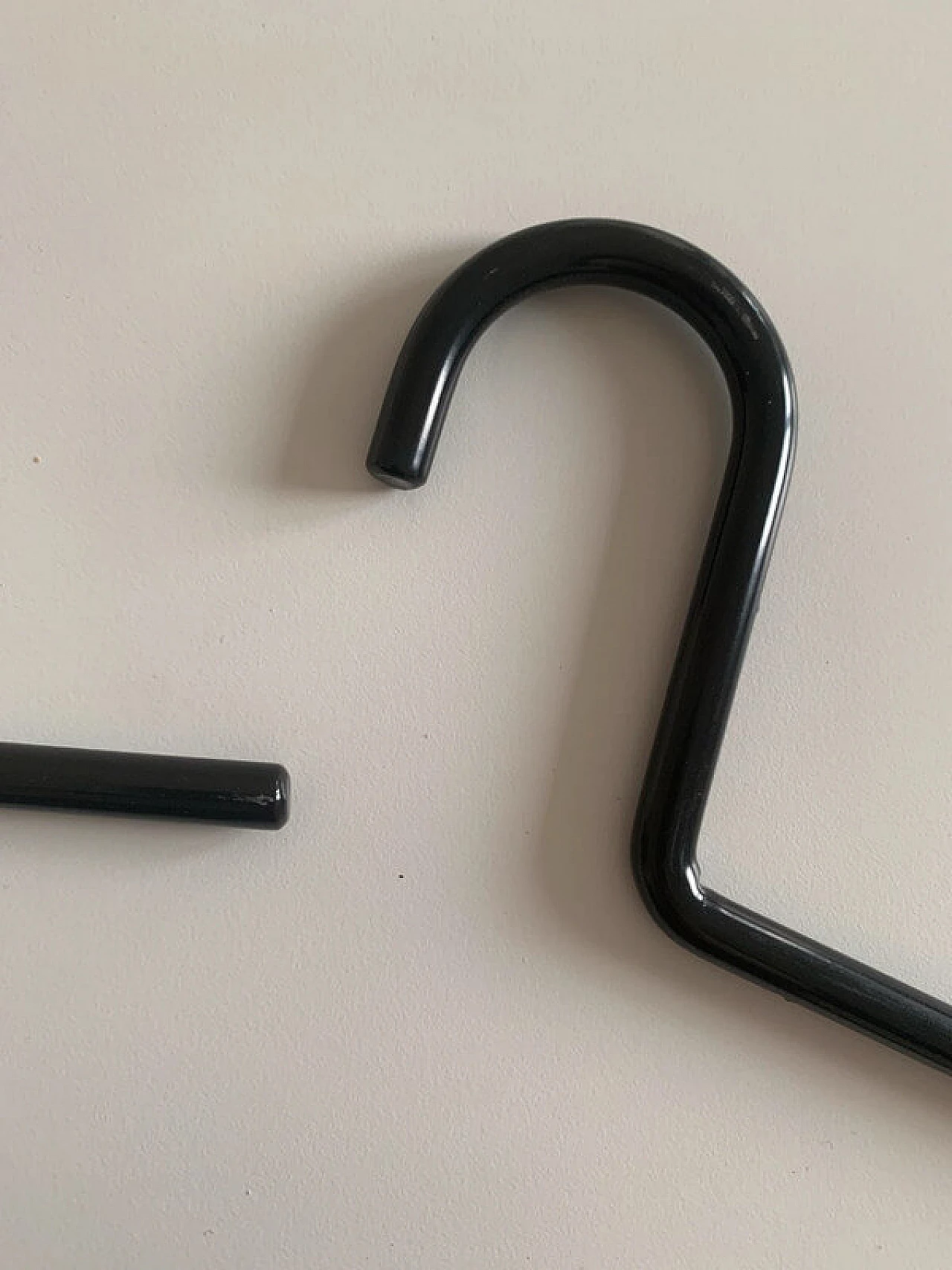 10 Black lacquered metal hangers, 1980s 12