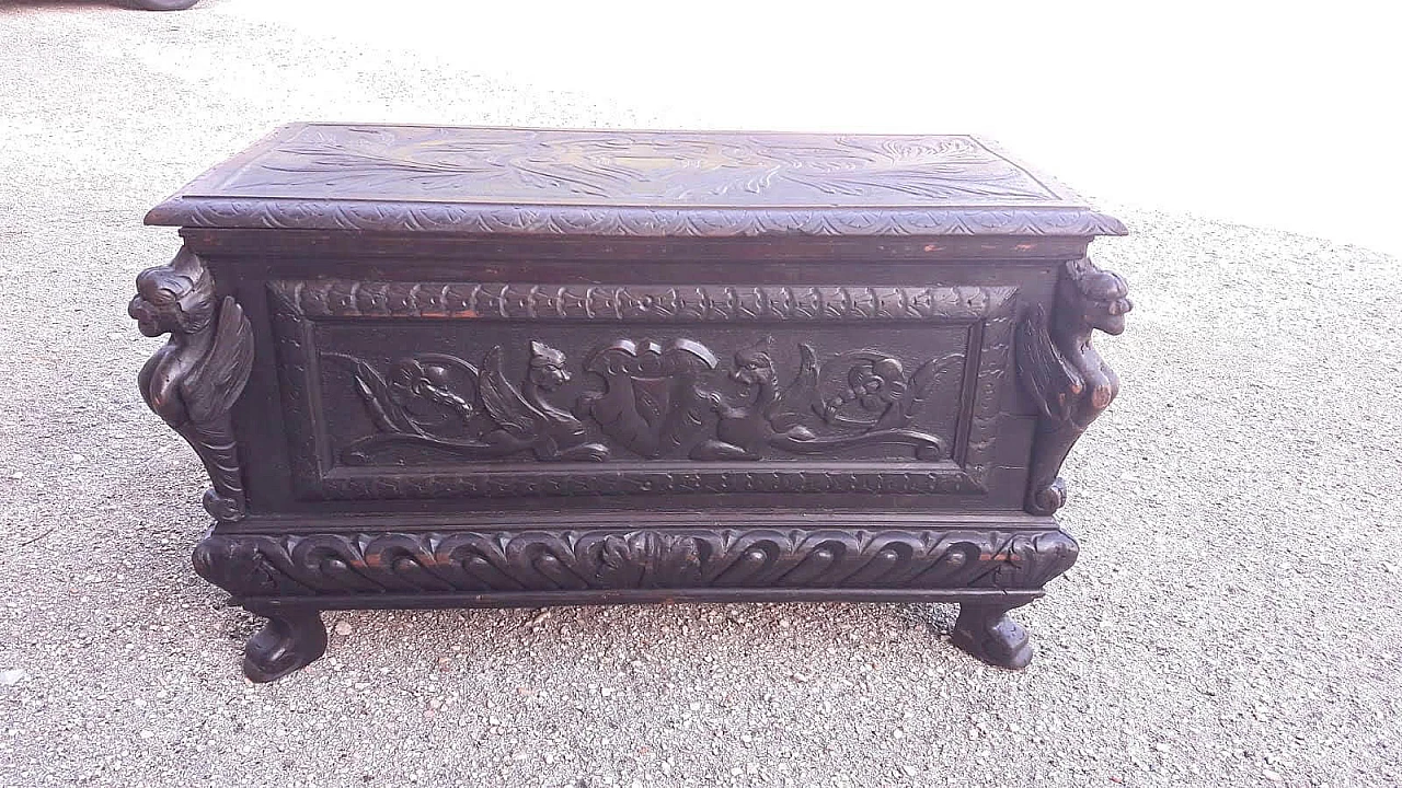 Wooden case carved with emblem and winged animals, late 19th century 3