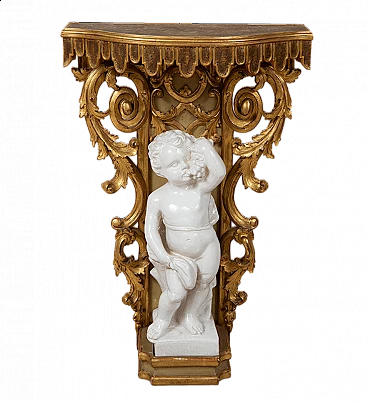 Carved wooden console table with glazed ceramic putto, early 20th century