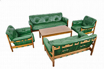 Pair of sofas with armchairs and coffee table in green leather in the style of Jean Gillon, 1970s
