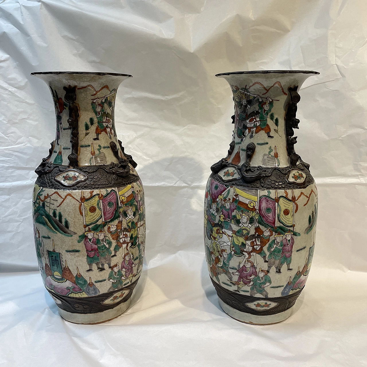 Pair of Chinese ceramic vases with war scenes and wooden details, 1920s 1