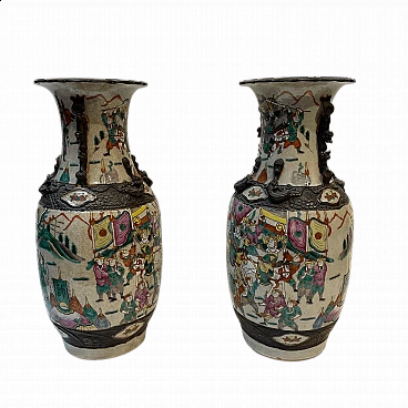 Pair of Chinese ceramic vases with war scenes and wooden details, 1920s