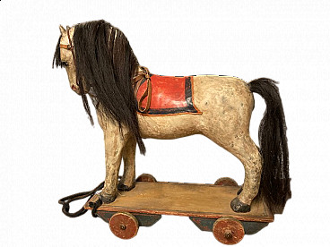 Painted wood and papier-mâché horse with wheels, late 19th century