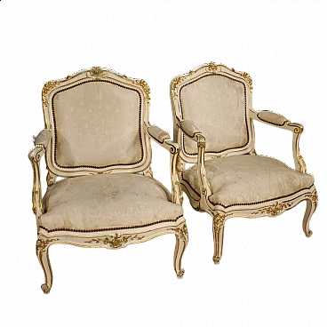Pair of French carved, lacquered and gilded wood armchairs