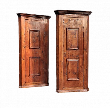 Pair of walnut-stained spruce corner cabinets, 18th century