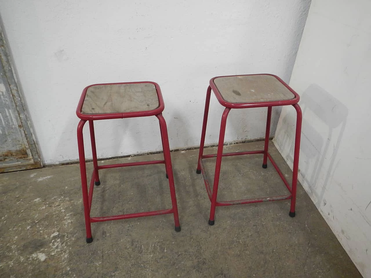 Pair of red iron and compressed wood stools, 1970s 1