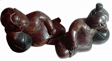 Pair of solid wood sculptures of sleeping figures, 1980s
