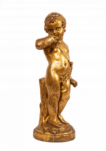Gilded and carved wooden sculpture of a joyful putto, 19th century