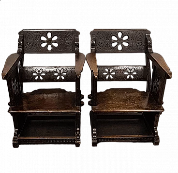 Pair of carved and decorated dark wood armchairs in the style of Ettore Zaccari, early 20th century