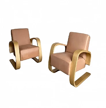 Pair of leather and wood armchairs by Alvar Aalto for Artek, 2000s