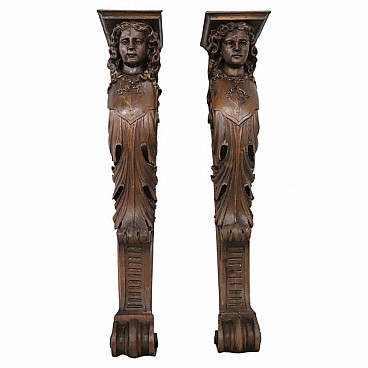 Pair of walnut half pilasters with carved caryatids, early 20th century