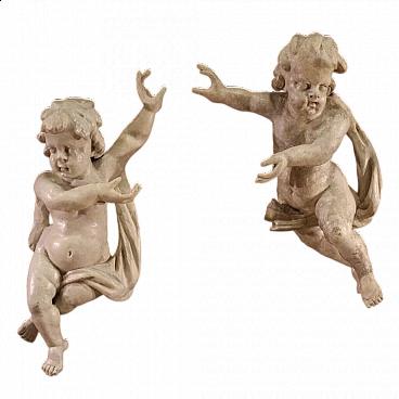 Pair of painted wooden sculptures of putti, 18th century