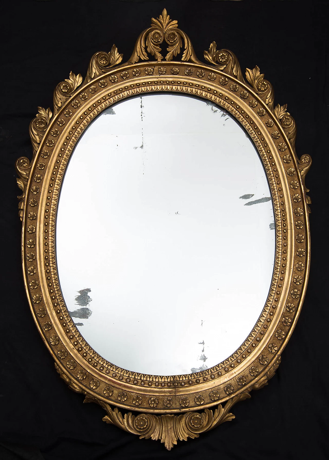 Neapolitan Empire mirror of oval shape in gilded and carved wood, early 19th century 1