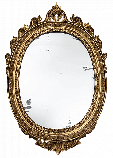 Neapolitan Empire mirror of oval shape in gilded and carved wood, early 19th century