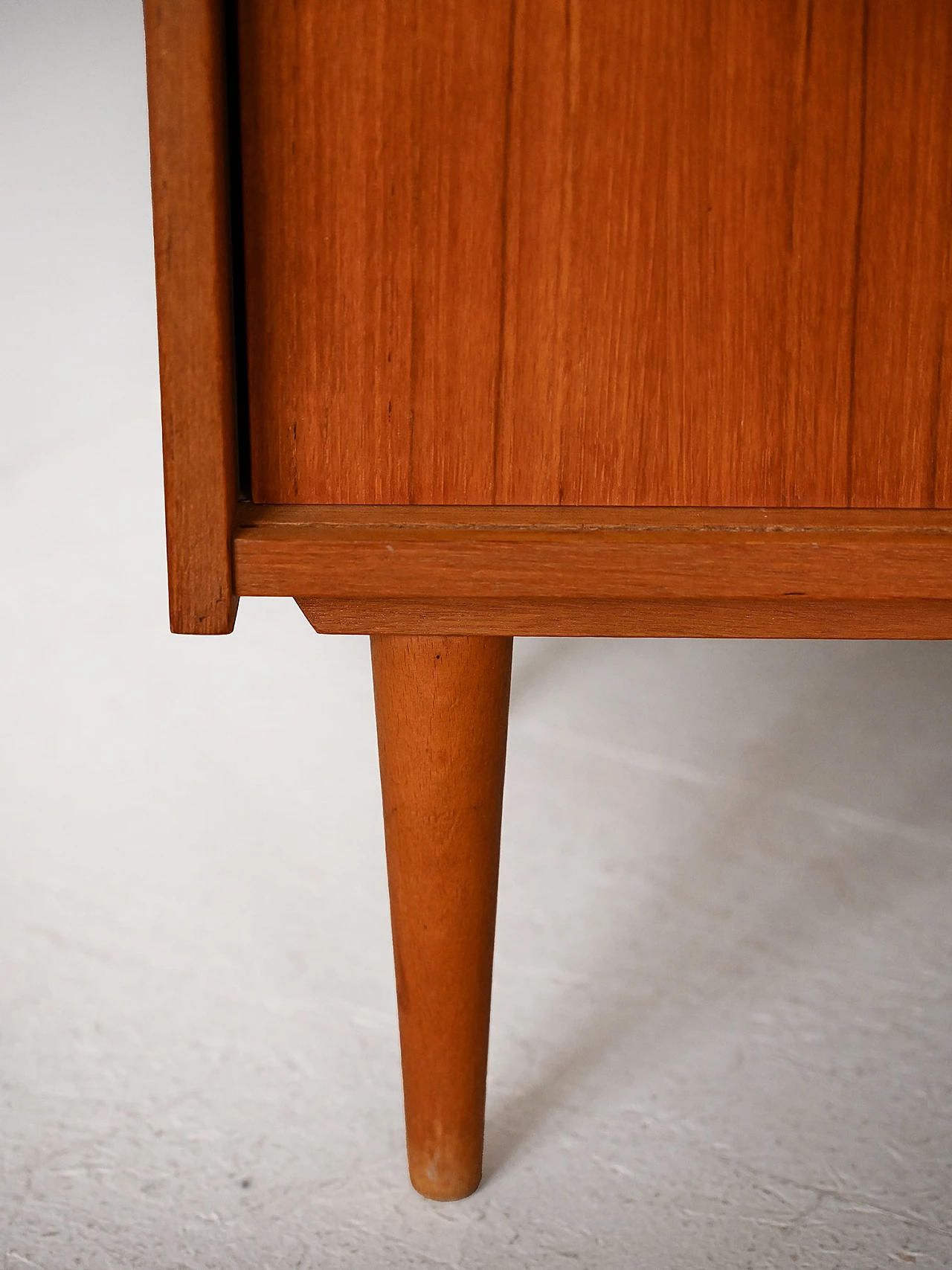 Teak sideboard with sliding doors with cone-shaped legs, 1960s 9