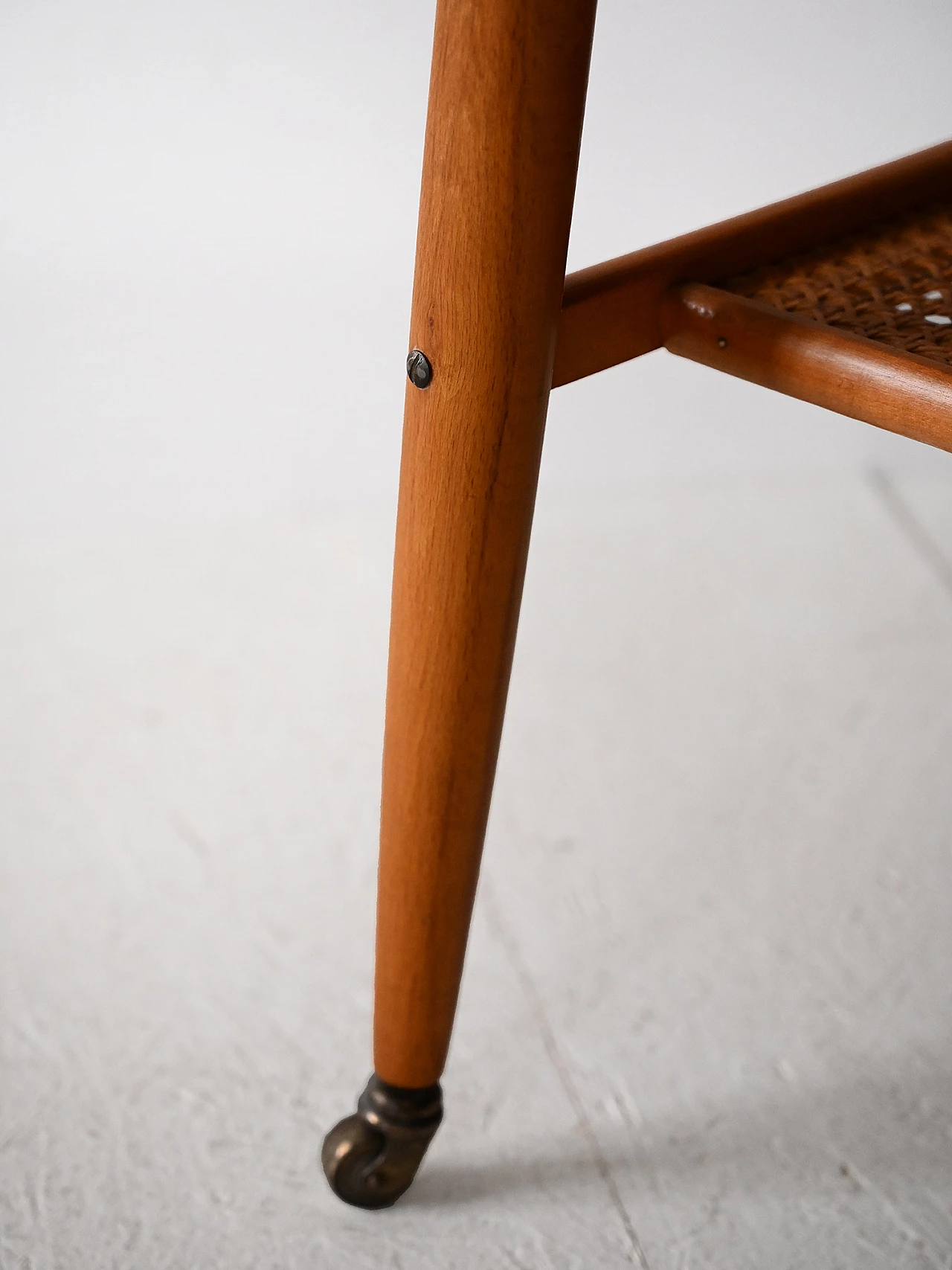 Teak coffee table with wheels and rattan magazine rack, 1960s 6