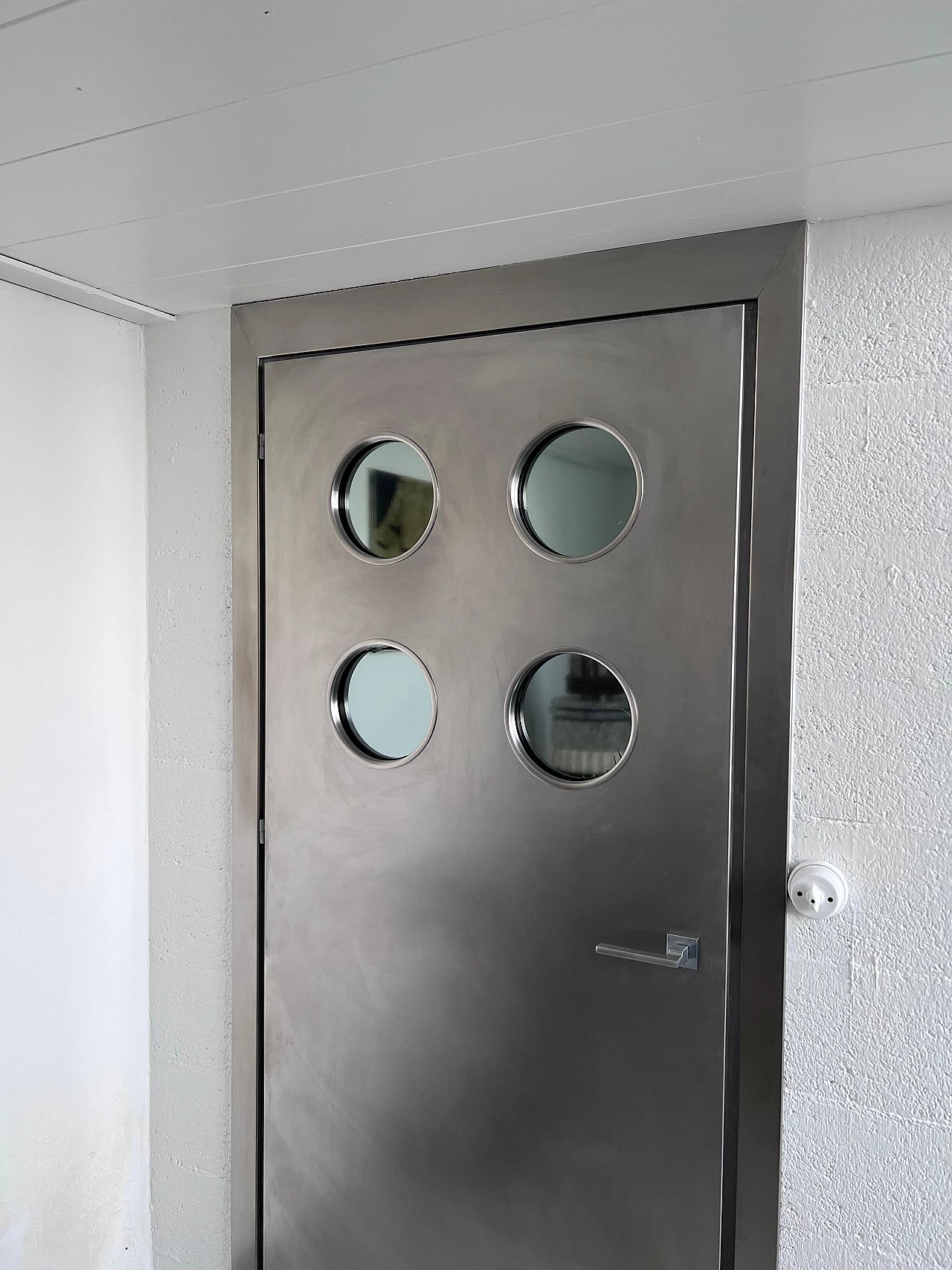 Steel door with portholes in the style of Jean Prouvé 4