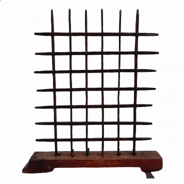 Black wrought iron grate with wooden base, 18th century