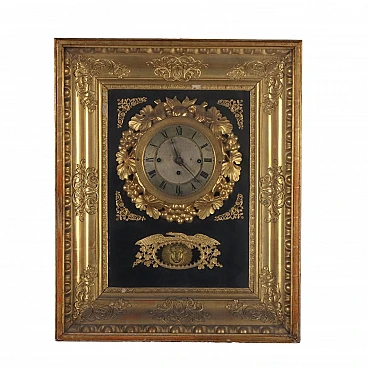 Golden wood wall clock with floral decoration, 19th century