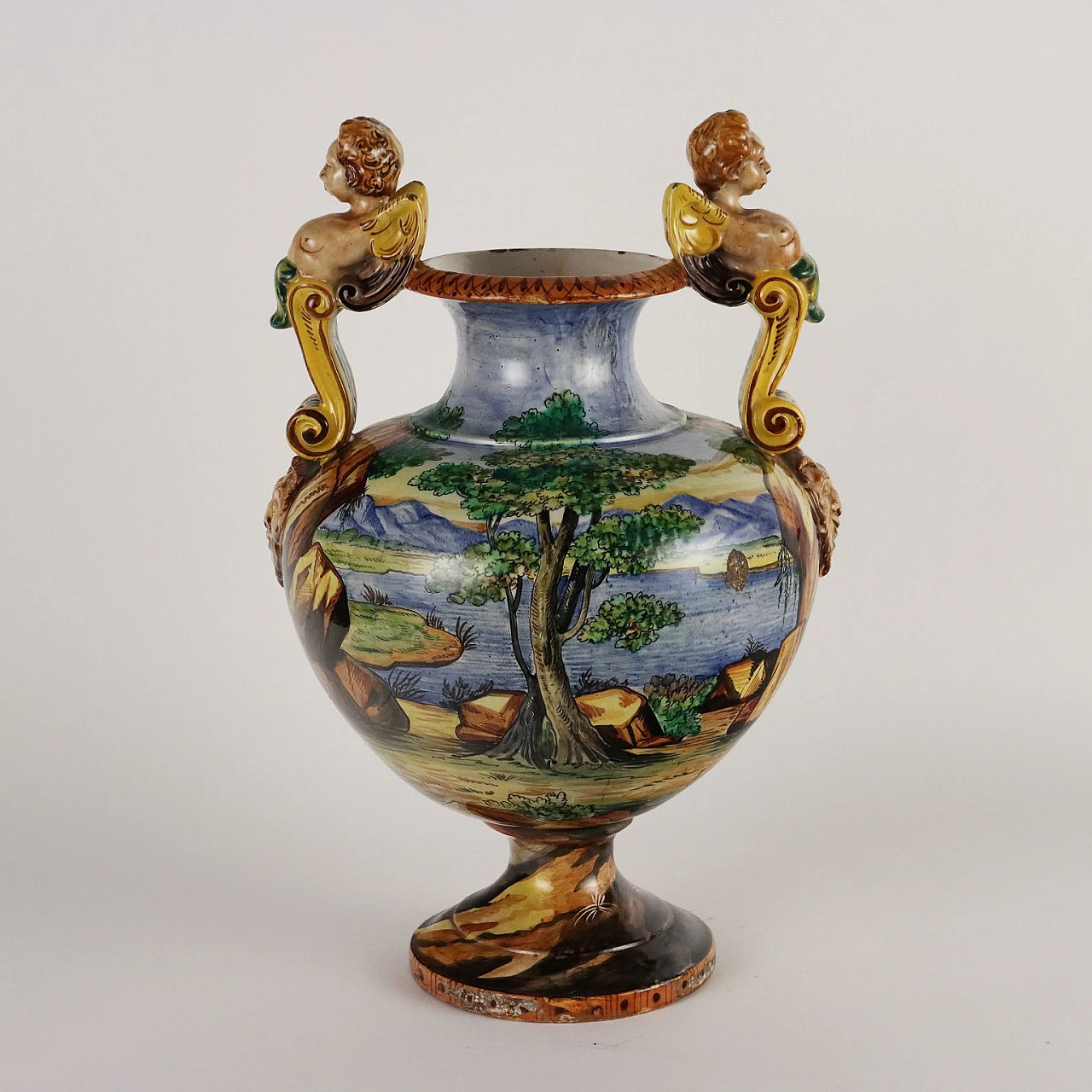 Painted majolica vase with winged figures and masks 10