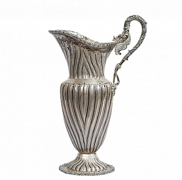 Silver sinusoidal-shaped jug with thick chisel on the edge
