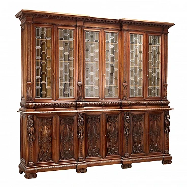 Carved walnut bookcase with leaded glass doors, 19th century