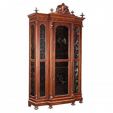 Carved walnut showcase with turned feet and back-painted glass