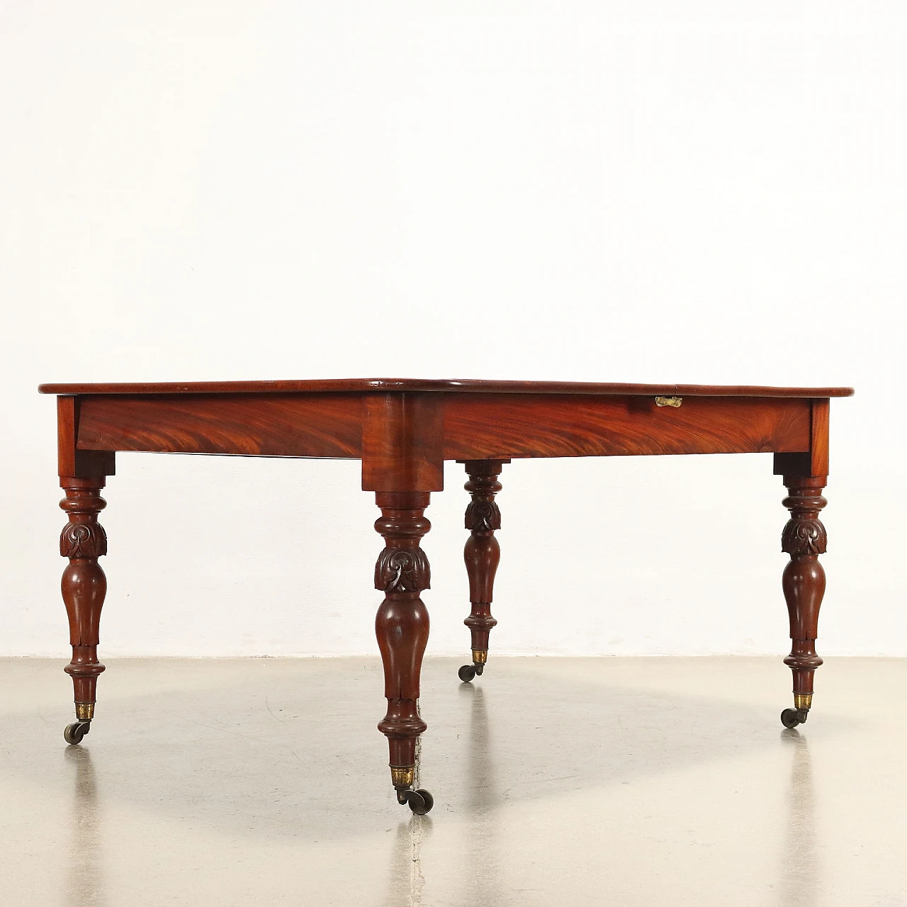 Mahogany extending table with wheels, early 20th century 9