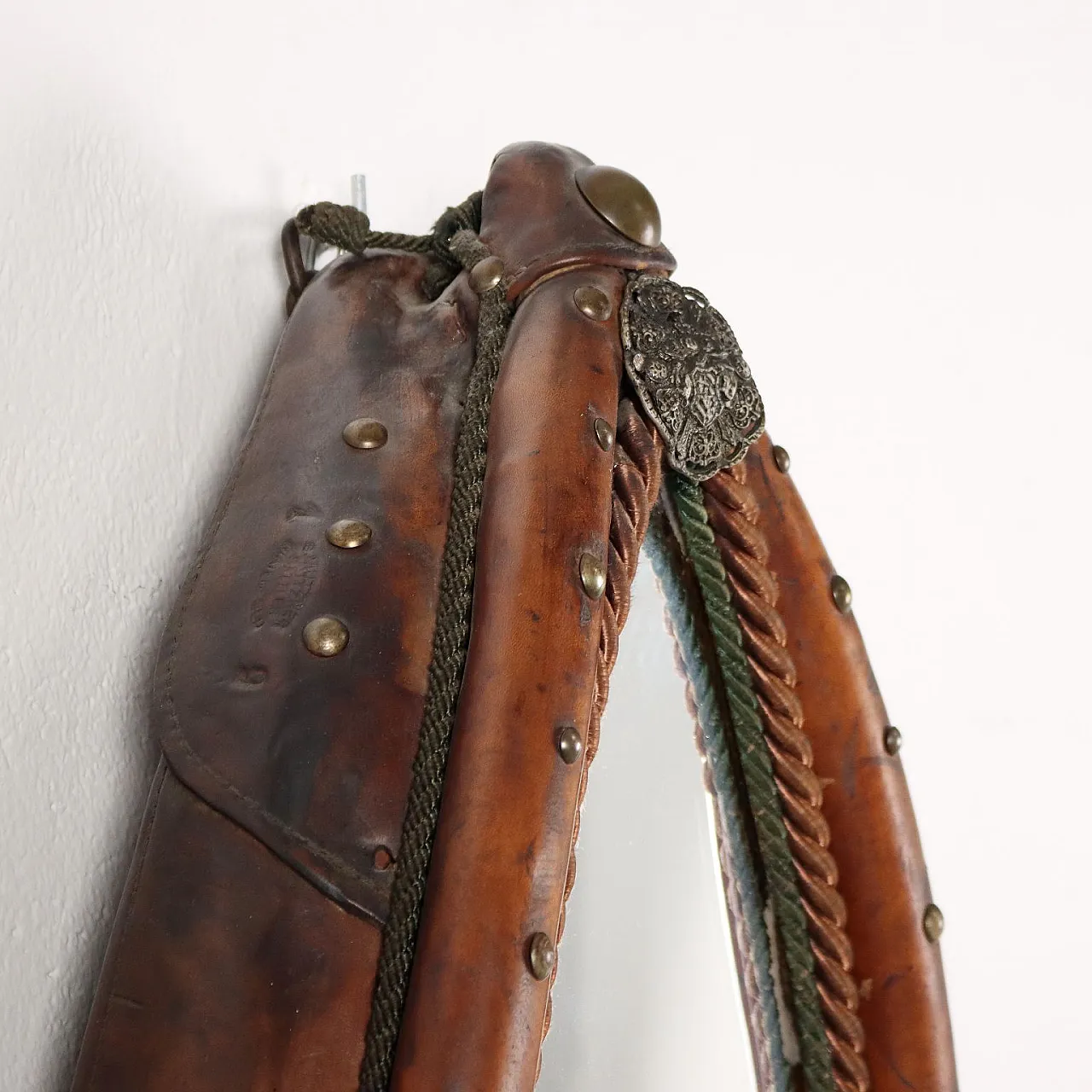 Mirror inside a leather riding saddle with studs 4