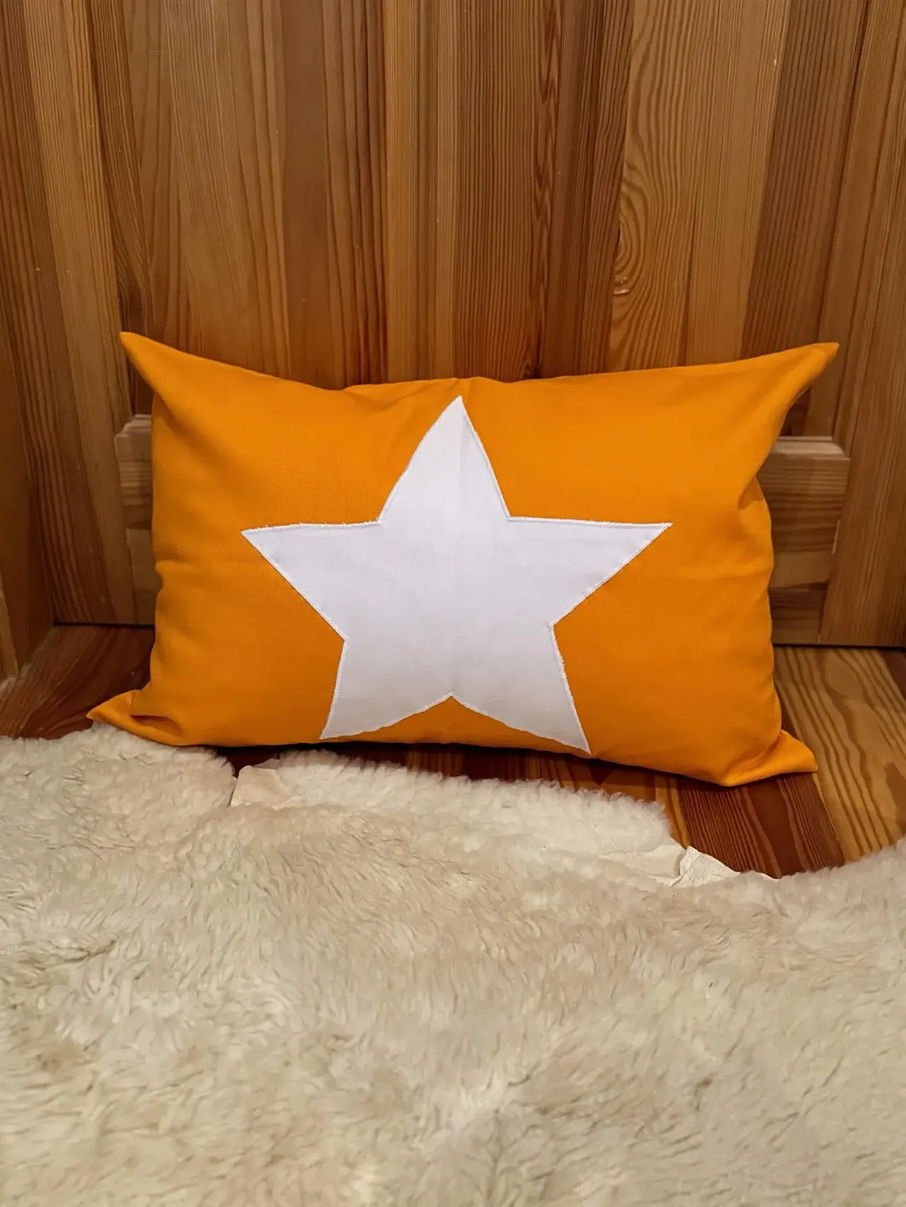 Yellow fabric pillow with white star, 2000s 1