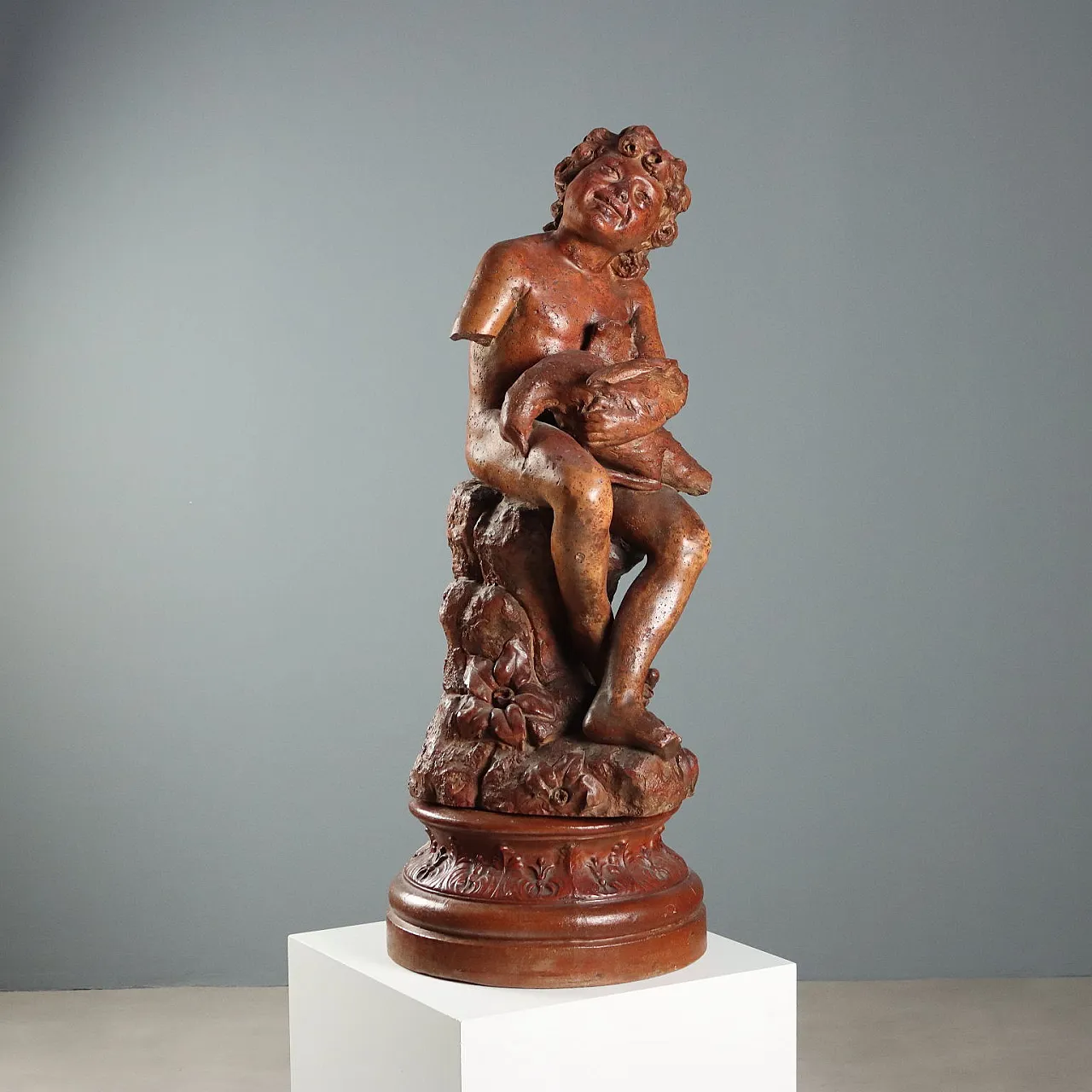 Patinated terracotta sculpture depicting boy with dove, 20th century 1