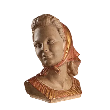 Female face in patinated terracotta, painted and gilded, 20th century