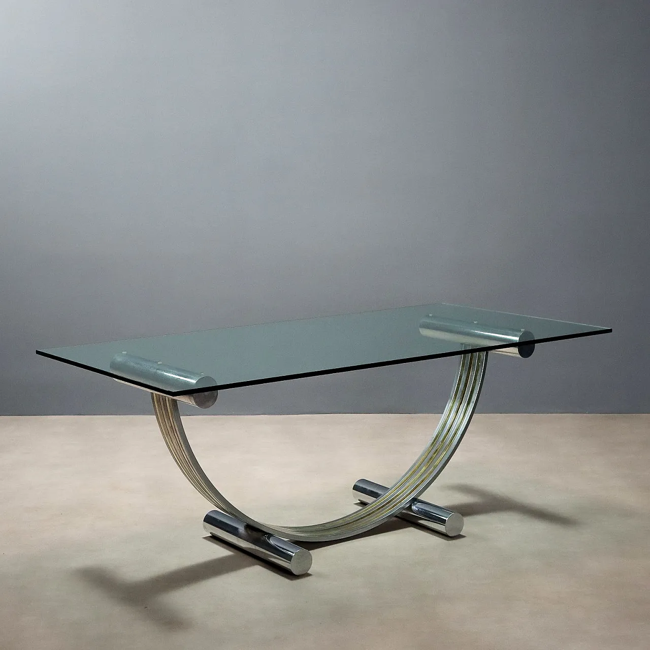 Table with glass top, metal and brass arched base, 20th century 1