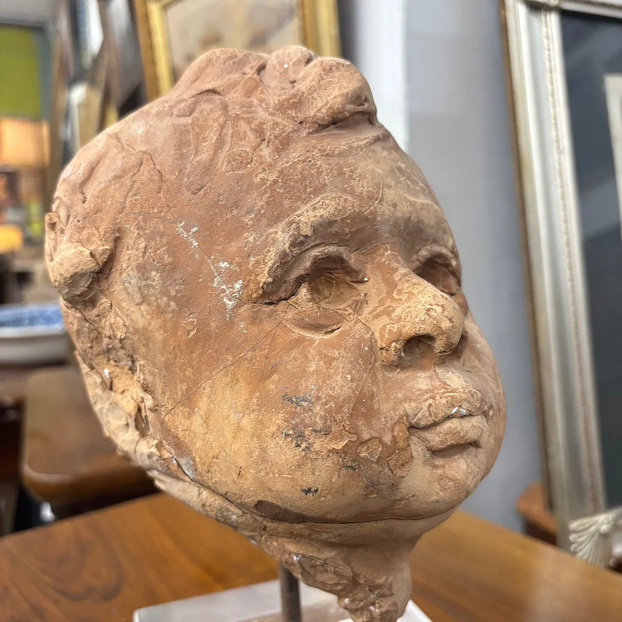 Ancient 19th century terracotta sculpture of the head of an Angel Putto. Size 7