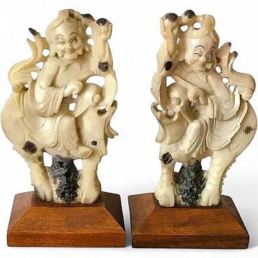 Carved stone sculptures of Qilin knights on wooden bases, early 20th century