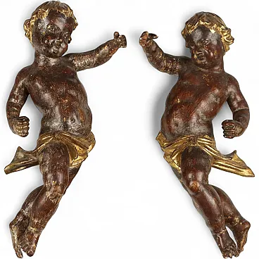 Pair of carved wooden putti, 19th century